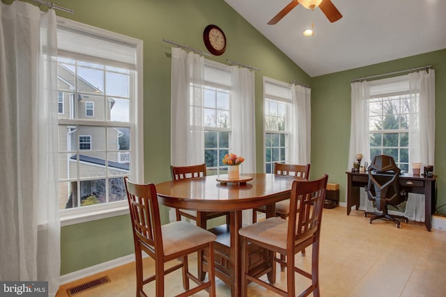 dining area with plenty of natural light, visible vents, vaulted ceiling, and baseboards