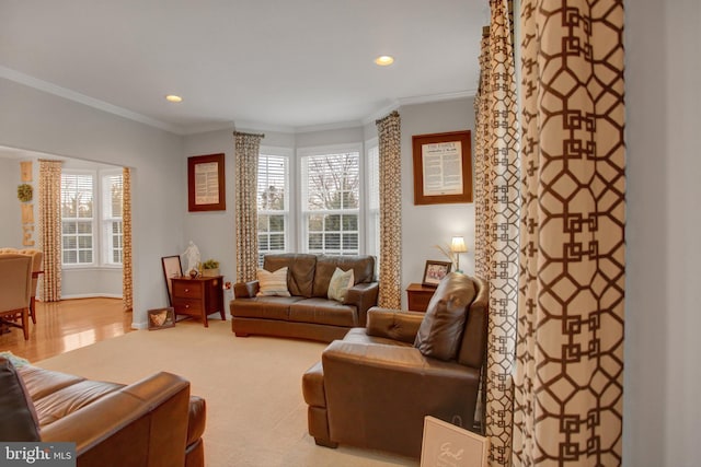 living room with a healthy amount of sunlight, ornamental molding, and recessed lighting