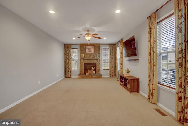 unfurnished living room with recessed lighting, visible vents, a fireplace, and baseboards