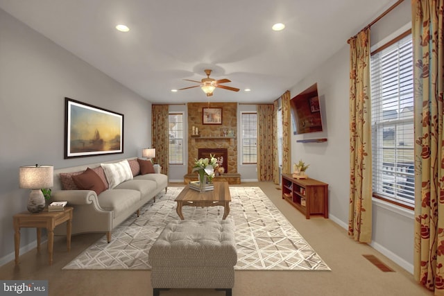 living room with a fireplace, recessed lighting, visible vents, a ceiling fan, and baseboards