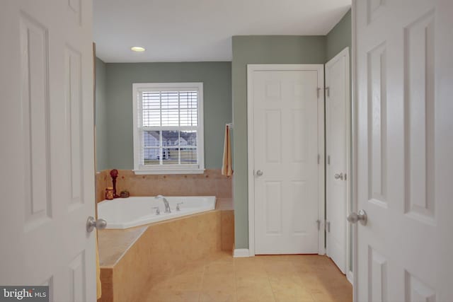 bathroom featuring a garden tub and tile patterned floors