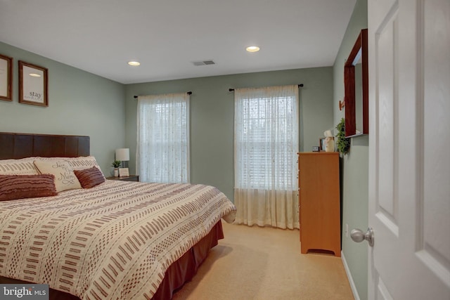 bedroom featuring recessed lighting, light carpet, visible vents, and baseboards