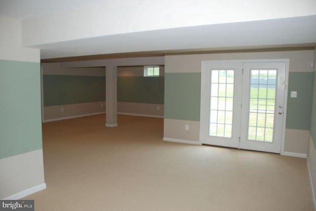 unfurnished room featuring carpet and baseboards