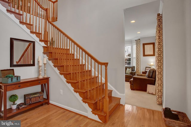 staircase featuring recessed lighting, wood finished floors, and baseboards