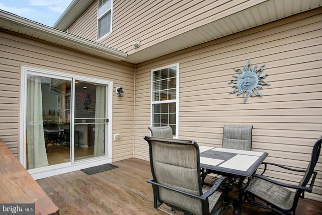 wooden deck featuring outdoor dining area