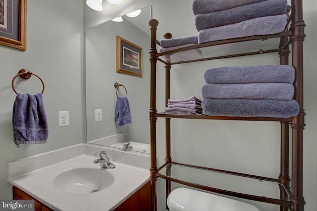 half bathroom with toilet and vanity