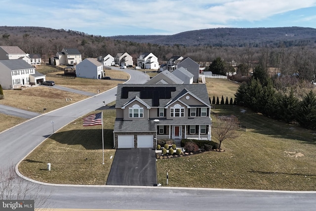 drone / aerial view with a residential view, a mountain view, and a view of trees