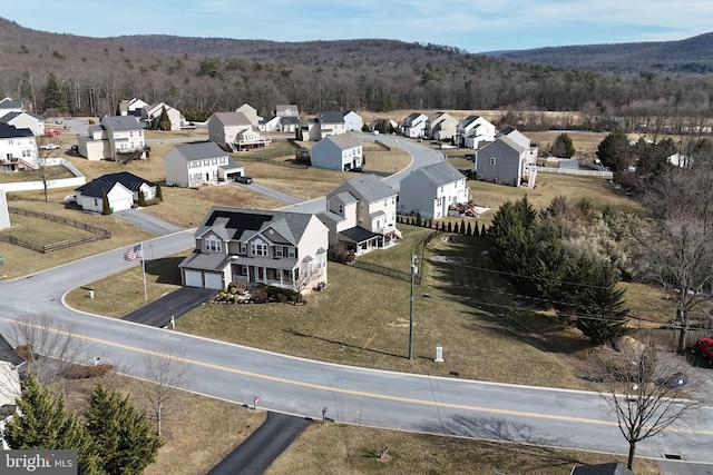 birds eye view of property featuring a forest view and a residential view