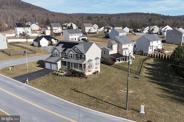 drone / aerial view with a forest view and a residential view