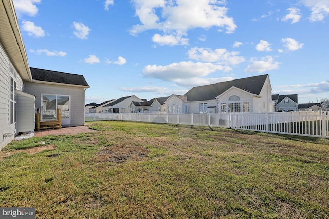 view of yard with a fenced backyard and a residential view