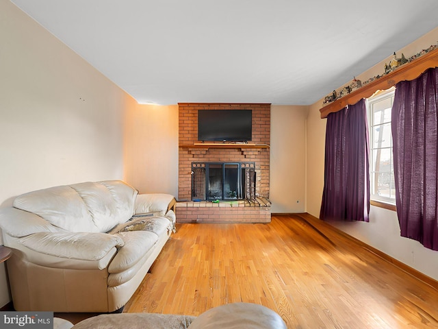 living area with a fireplace and wood finished floors