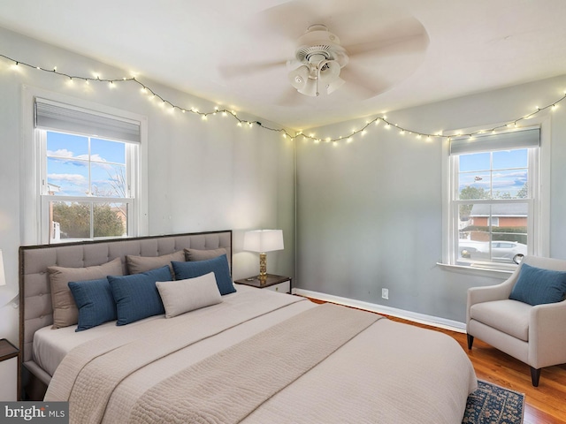 bedroom with wood finished floors and baseboards