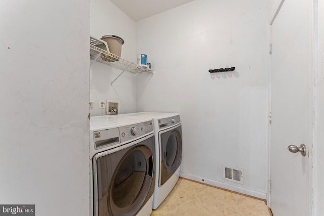 laundry area featuring visible vents, laundry area, and washer and clothes dryer