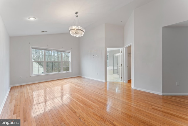 interior space featuring visible vents, baseboards, a notable chandelier, and light wood-style flooring