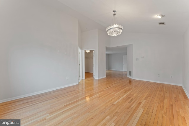 interior space with light wood finished floors, visible vents, a notable chandelier, and baseboards