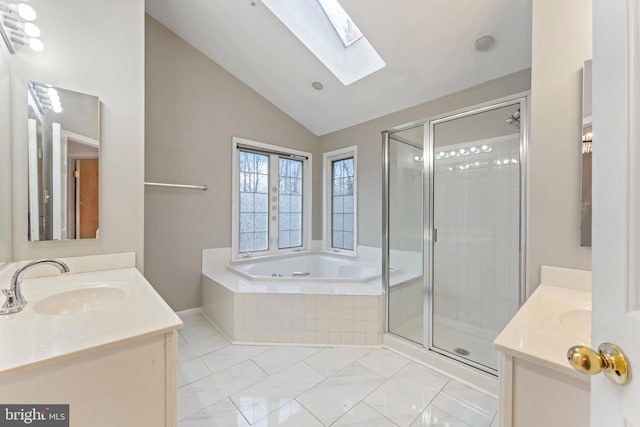 bathroom with two vanities, a sink, a shower stall, lofted ceiling with skylight, and a bath