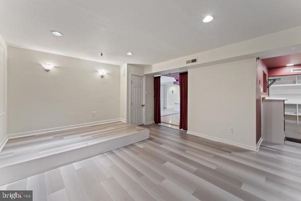 unfurnished room featuring recessed lighting, visible vents, baseboards, and wood finished floors