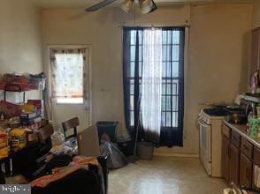 interior space with ceiling fan
