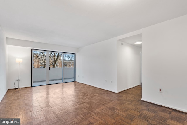 empty room featuring baseboards