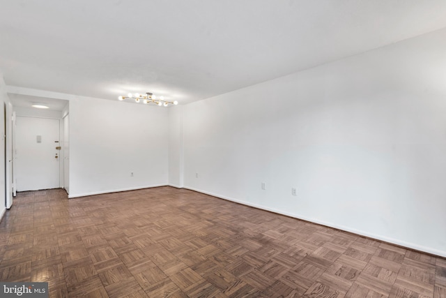 unfurnished room with baseboards