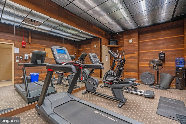 workout area featuring wooden walls