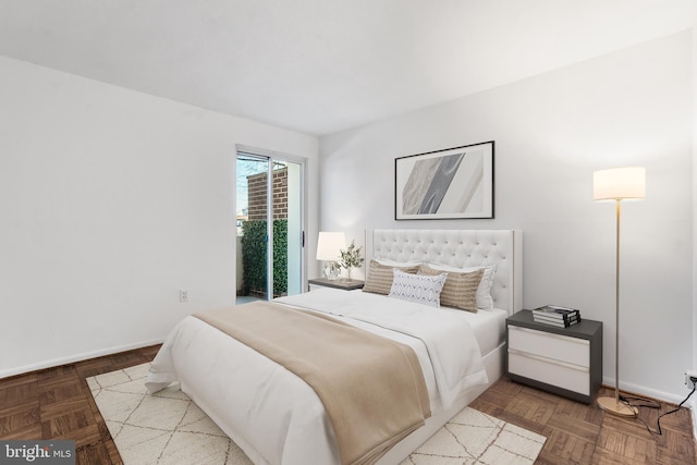 bedroom featuring access to outside and baseboards