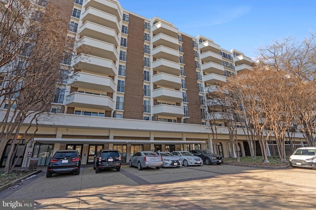 view of building exterior with uncovered parking