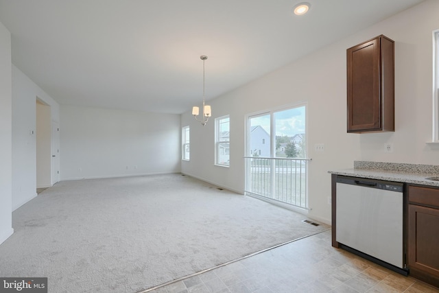 unfurnished dining area featuring light carpet, a notable chandelier, and baseboards