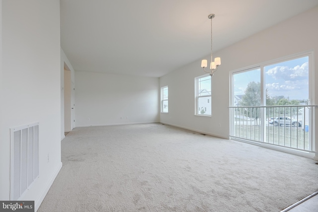 unfurnished room featuring a chandelier, carpet flooring, visible vents, and baseboards