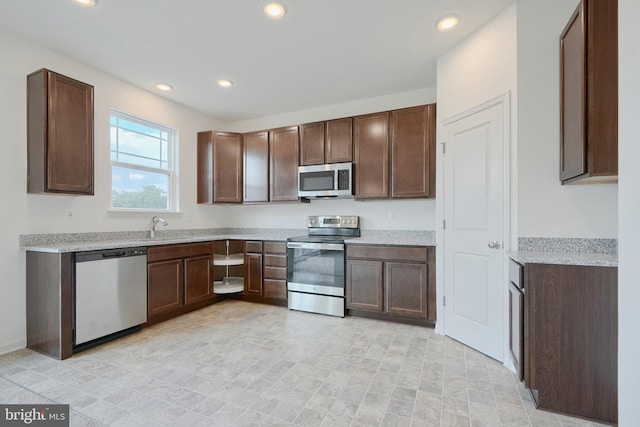 kitchen featuring stainless steel appliances, dark brown cabinets, and recessed lighting