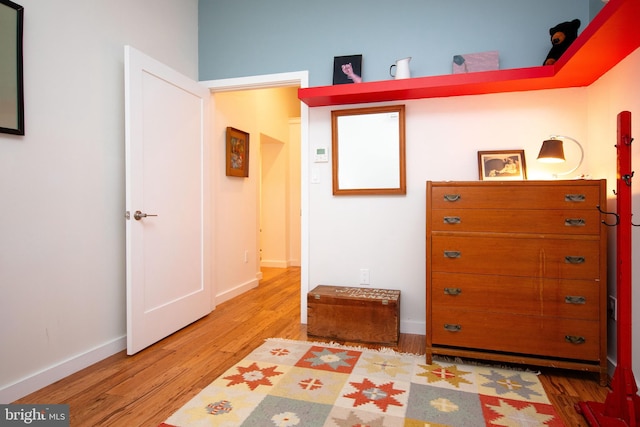 bedroom with light wood-style flooring and baseboards