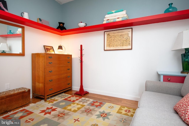 bedroom with wood finished floors and baseboards