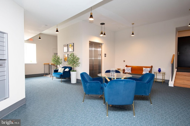 living room featuring baseboards, carpet floors, stairway, and elevator