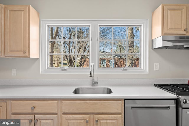 kitchen featuring light brown cabinets, under cabinet range hood, stainless steel appliances, a sink, and light countertops