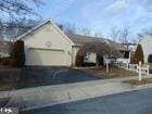 ranch-style house featuring an attached garage and aphalt driveway