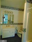 full bath with tile walls and vanity