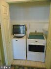 kitchen with stainless steel microwave and washer and clothes dryer