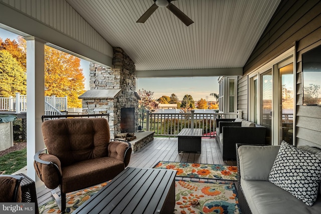 exterior space with an outdoor living space with a fireplace and ceiling fan