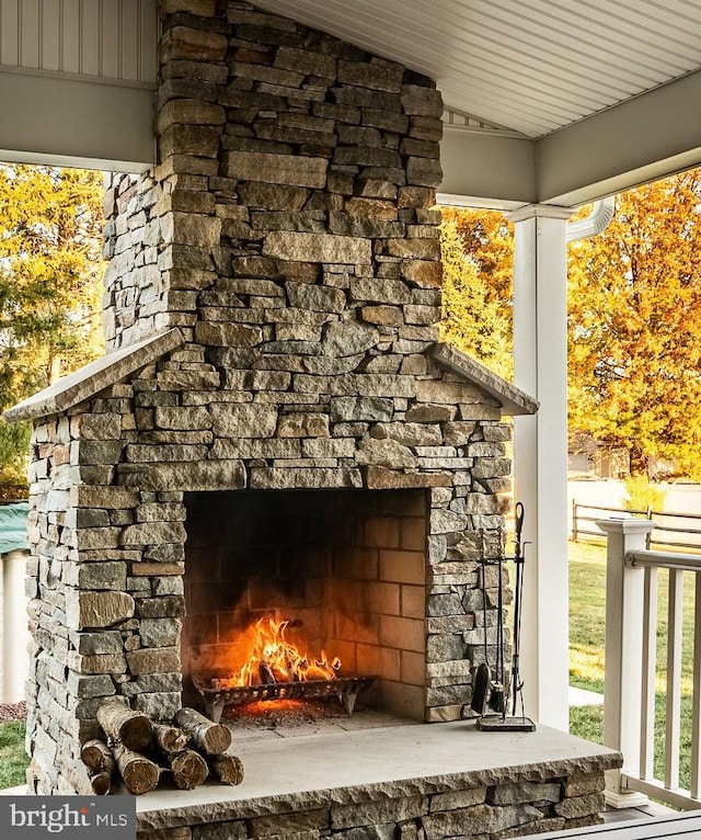 exterior details featuring an outdoor stone fireplace