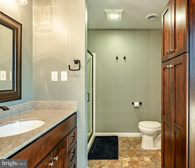 full bathroom with vanity, baseboards, visible vents, a shower stall, and stone finish flooring