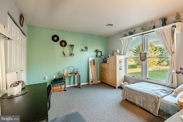 carpeted bedroom featuring baseboards and visible vents