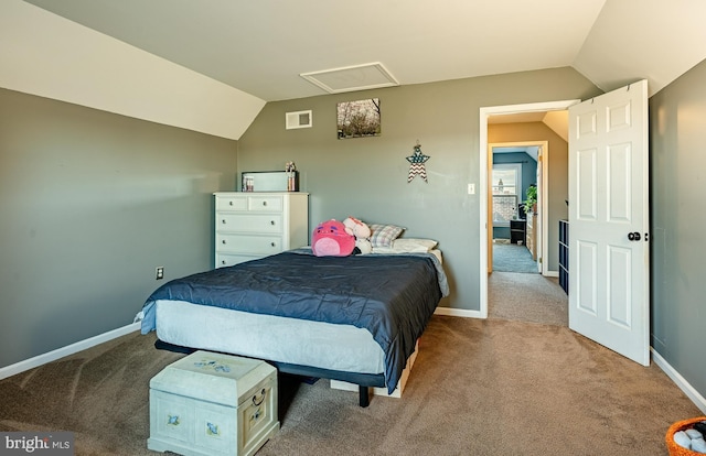 carpeted bedroom featuring lofted ceiling, attic access, visible vents, and baseboards