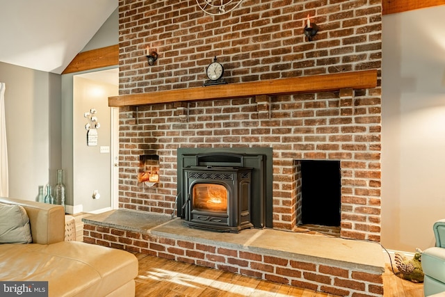 details featuring a wood stove and wood finished floors