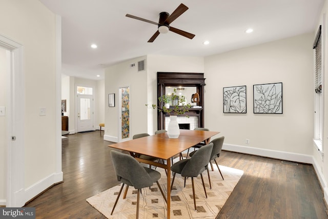 dining space with baseboards, dark wood-type flooring, visible vents, and recessed lighting