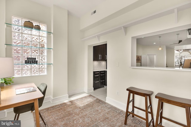 dining area featuring light tile patterned floors, baseboards, and visible vents