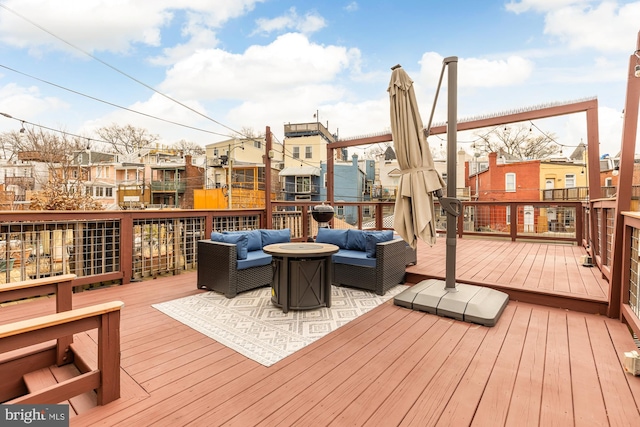 wooden terrace with a residential view and an outdoor living space with a fire pit