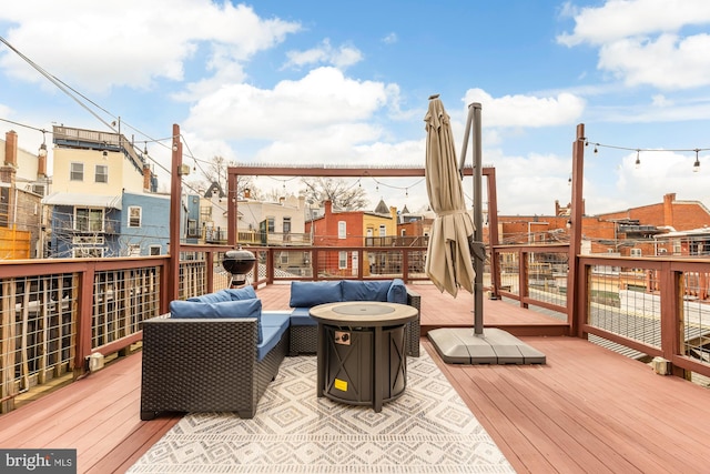 deck featuring a residential view and an outdoor living space with a fire pit