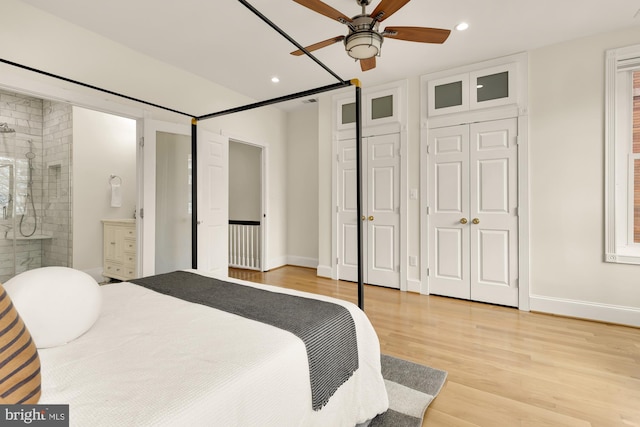 bedroom with baseboards, connected bathroom, light wood-style flooring, and recessed lighting