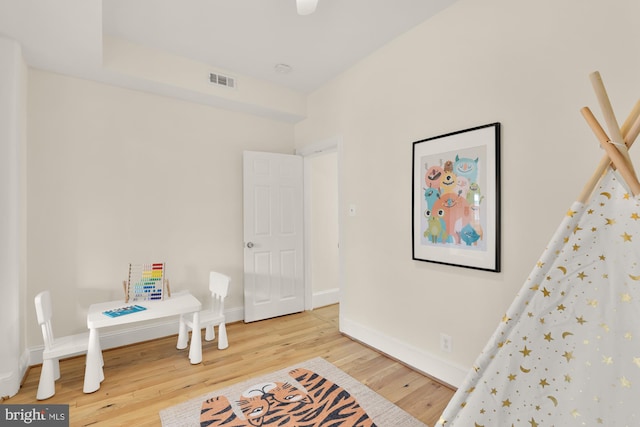 sitting room featuring baseboards, visible vents, and wood finished floors