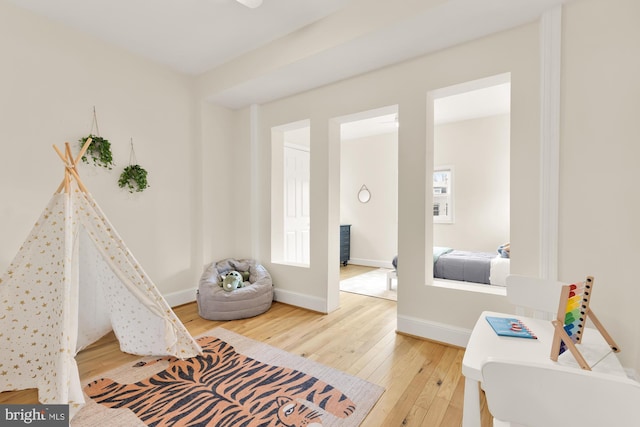 playroom with hardwood / wood-style flooring and baseboards